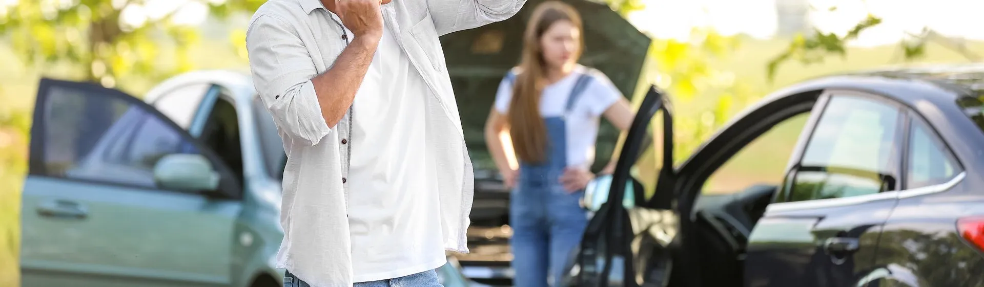 Man filing a police report on the phone after a car accident